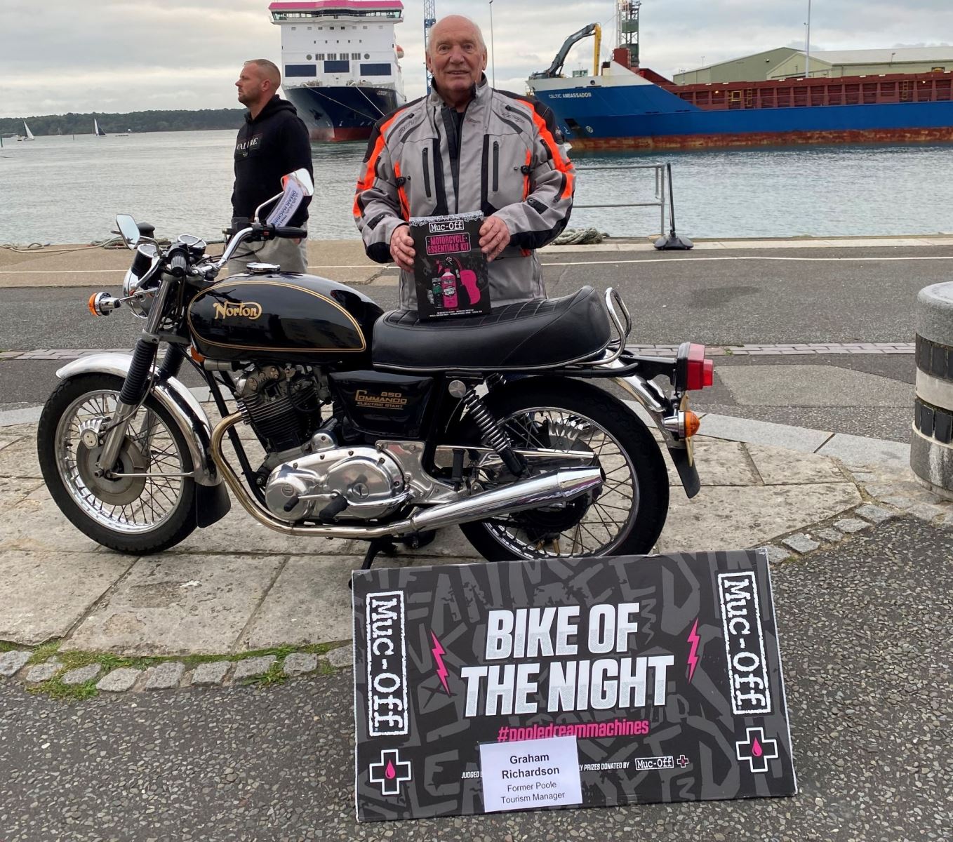 man stood next to his bike on Poole quay 